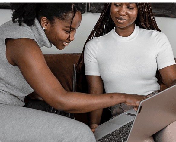 two women looking at laptop